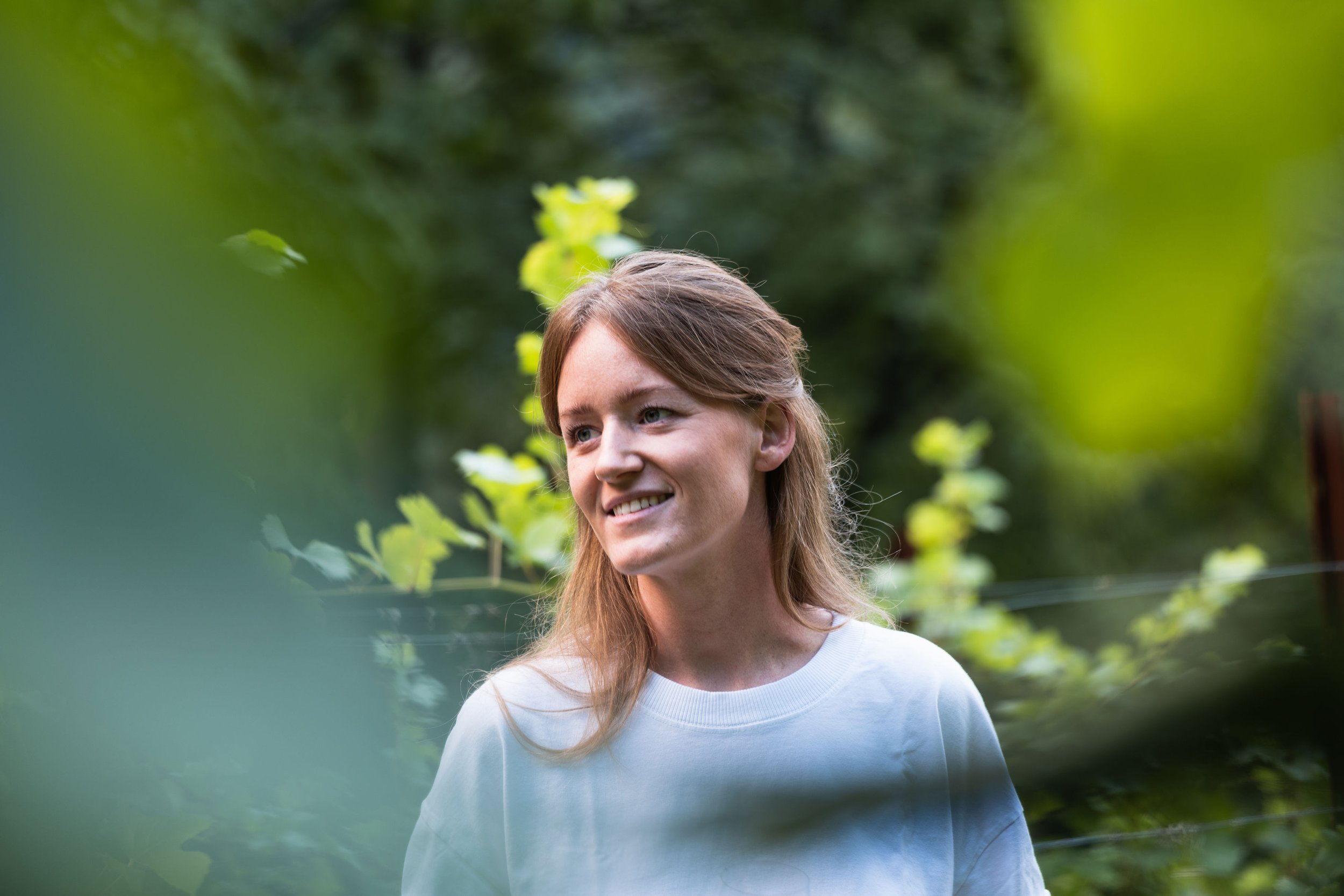 Fenja Hinz smiling in his vineyard in Montagna in Südtirol.